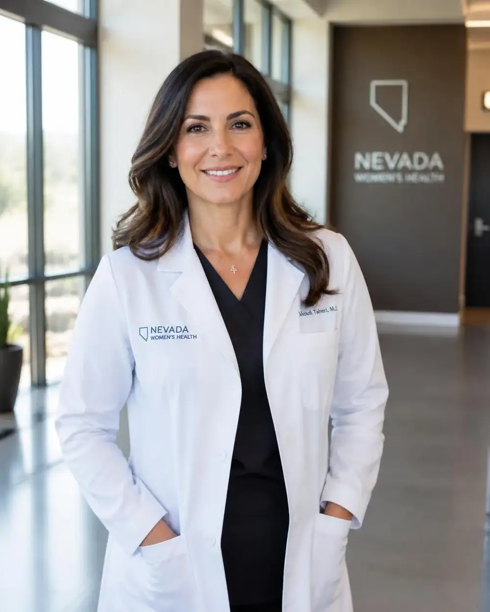 Nevada physician standing in a modern clinic hallway